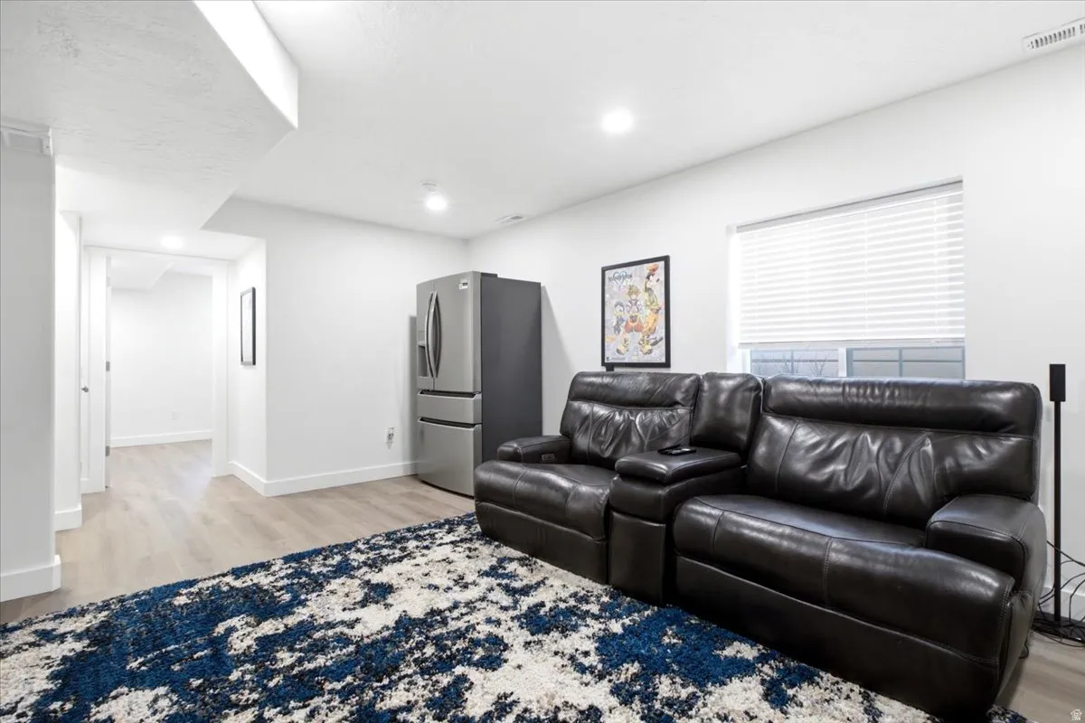 Recessed lighting illuminates wood-finish flooring