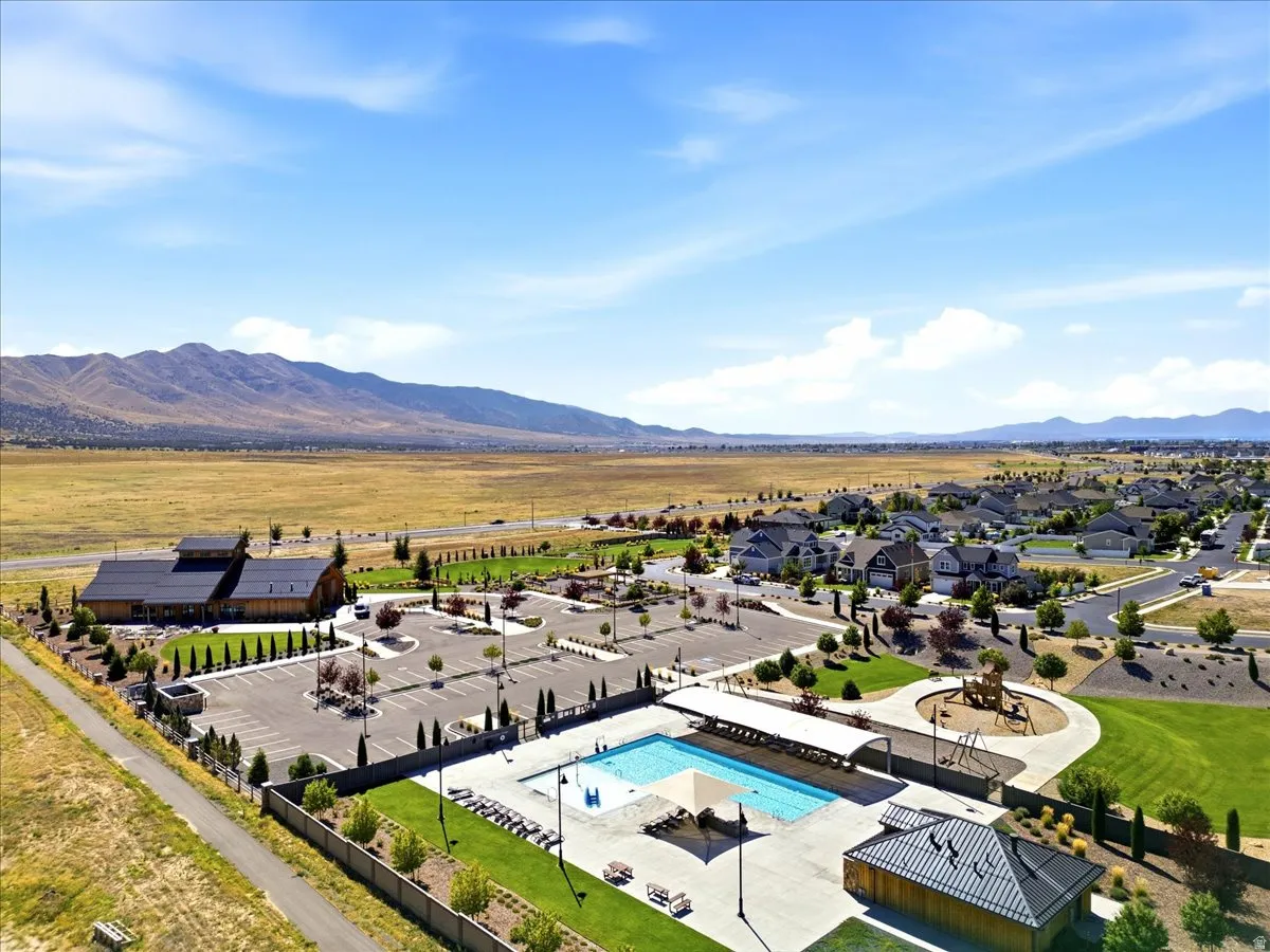 Community amenities featuring an outdoor swimming pool, playground, and extensive green spaces