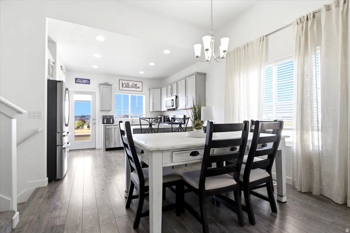 Vaulted ceilings, recessed lighting, stainless steel appliances, and a glass-paneled exterior door