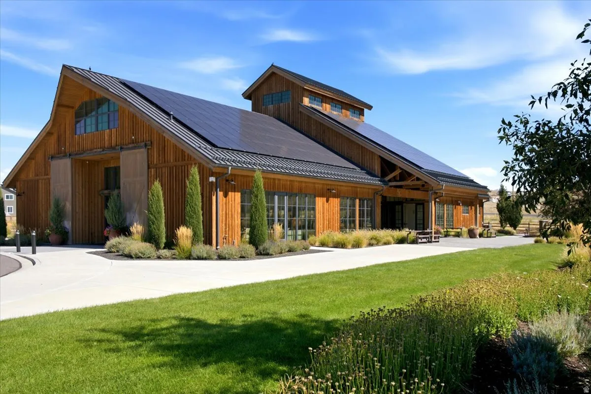 Modern barn-style architecture featuring natural wood siding and a gambrel roof