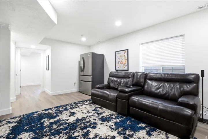 Recessed lighting illuminates wood-finish flooring