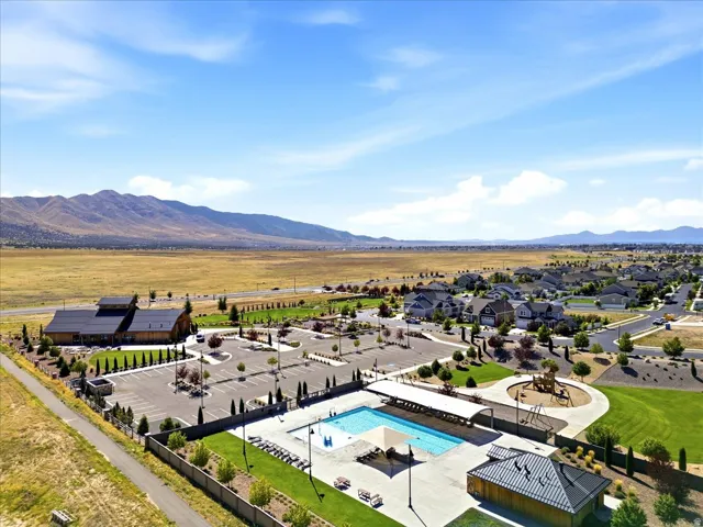 Community amenities featuring an outdoor swimming pool, playground, and extensive green spaces