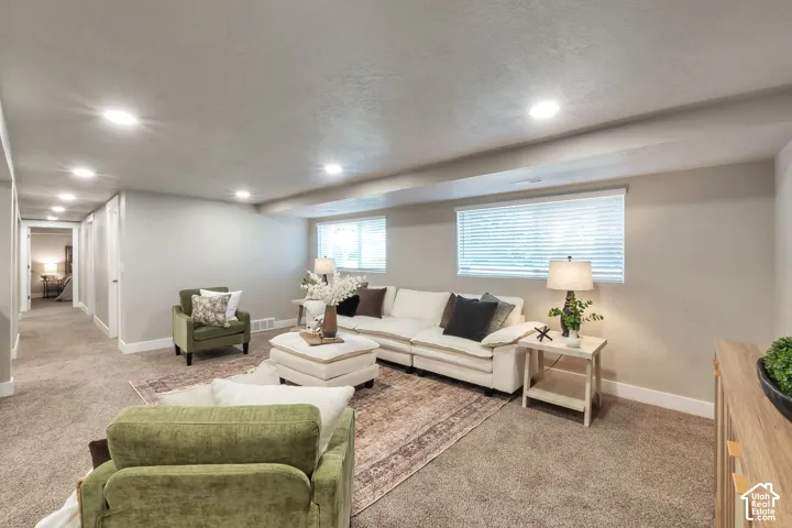 Recessed ceiling lighting, carpeted flooring, and a neutral wall color
