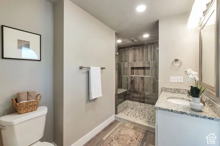 Glass-enclosed shower with a built-in bench and pebble-tile flooring