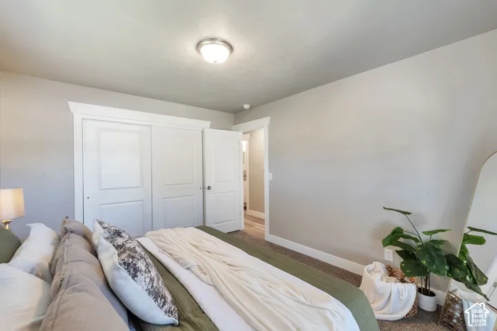 Recessed lighting with a neutral ceiling, a white paneled closet with trim, and light-toned wall paint