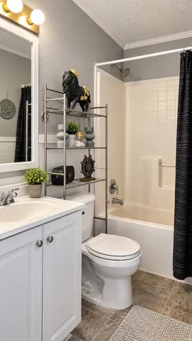 White vanity with brushed nickel hardware, a white sink, and a chrome faucet