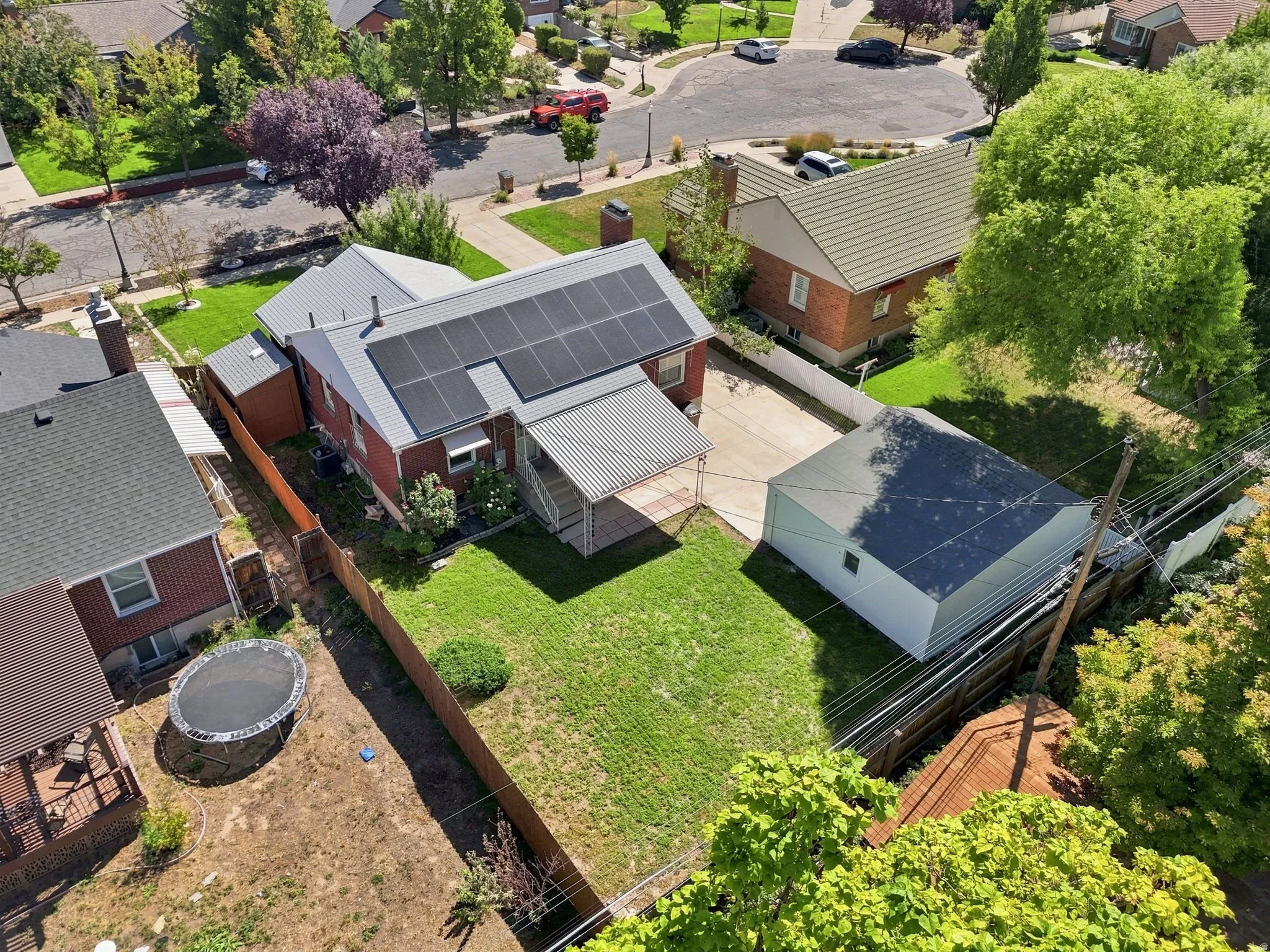 Red brick exterior with a metal roof, featuring solar panels