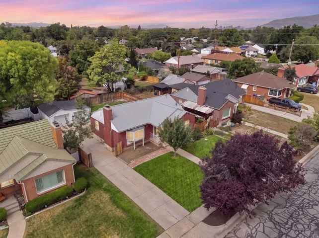 Brick exterior residence with a gray metal roof