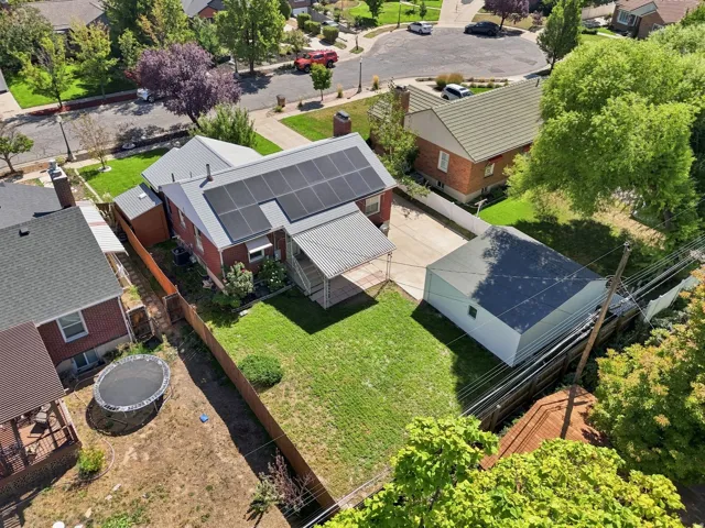 Red brick exterior with a metal roof, featuring solar panels