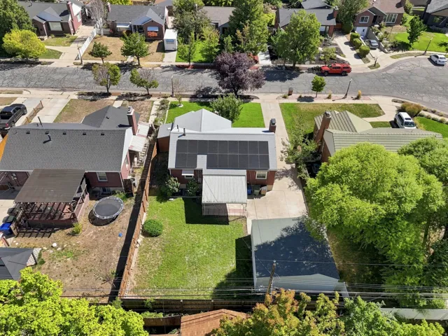 Property featuring a gabled roof, solar panel array, and a paved driveway