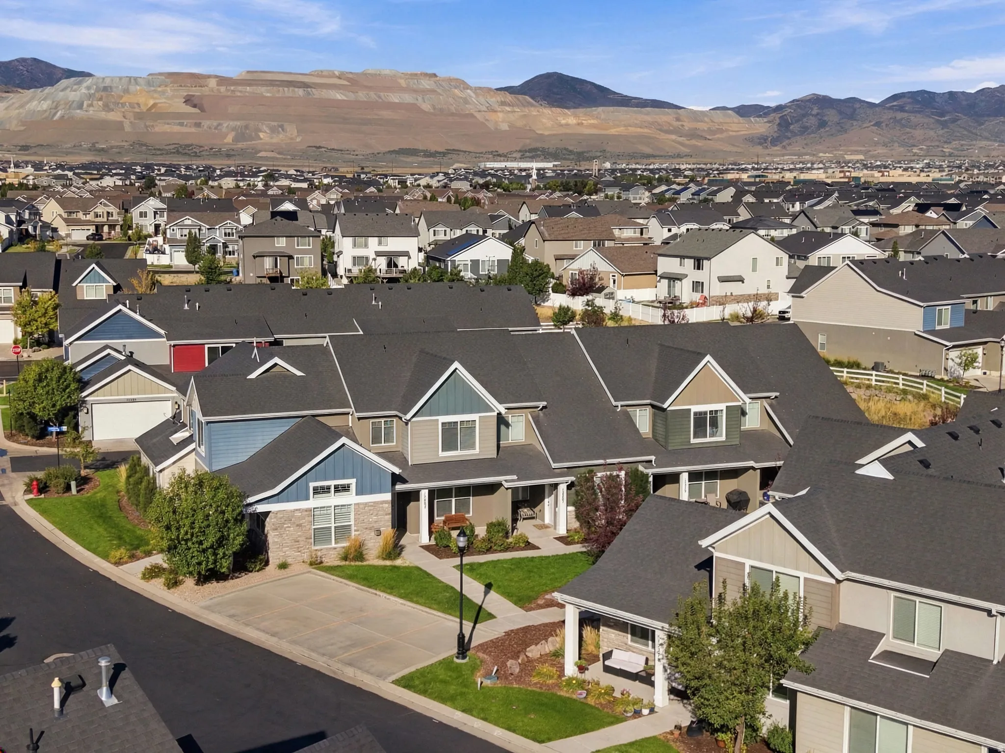 Residential community with pitched roofs, front lawns, and mature landscaping