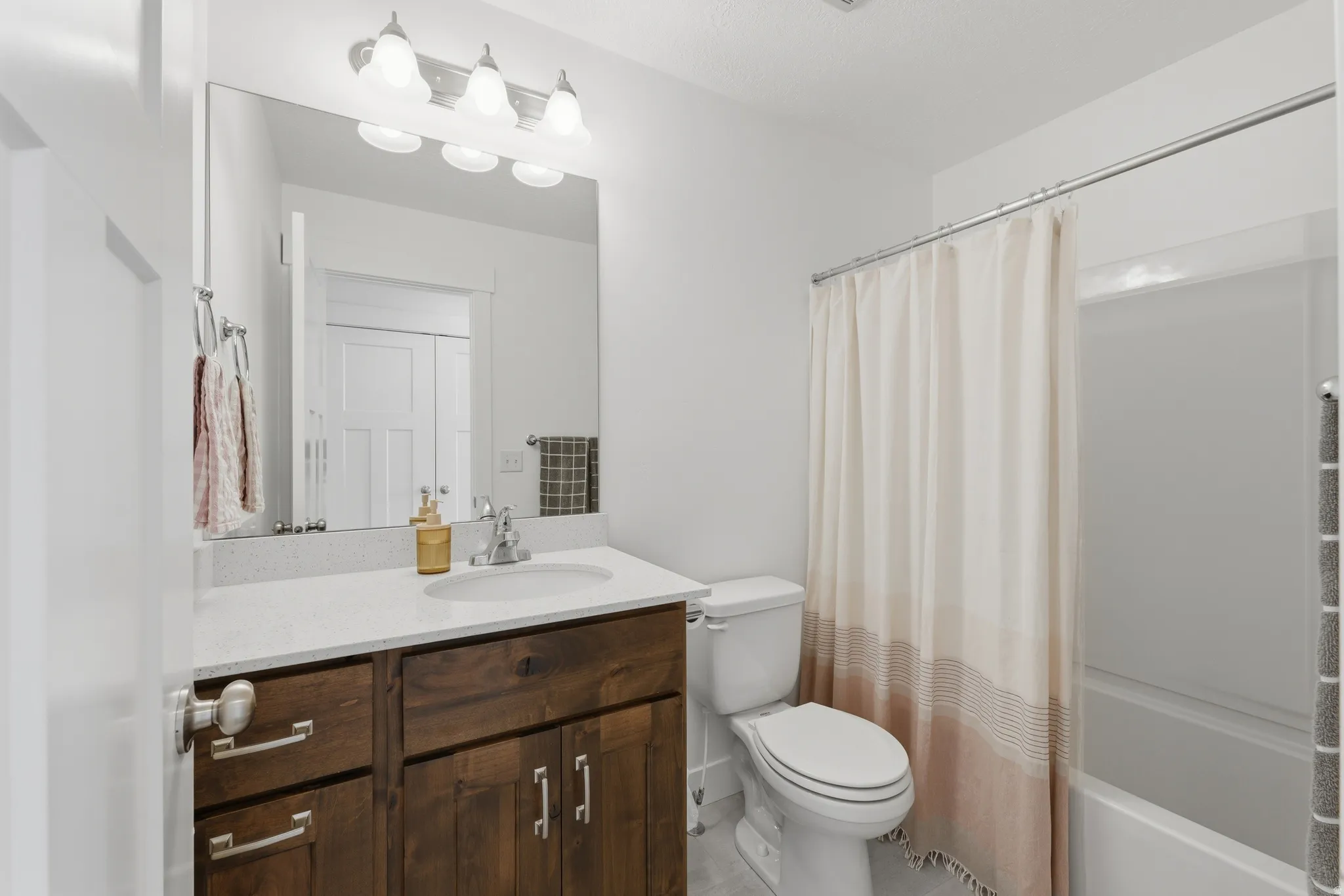 White shower-over-tub combination with a chrome shower rod
