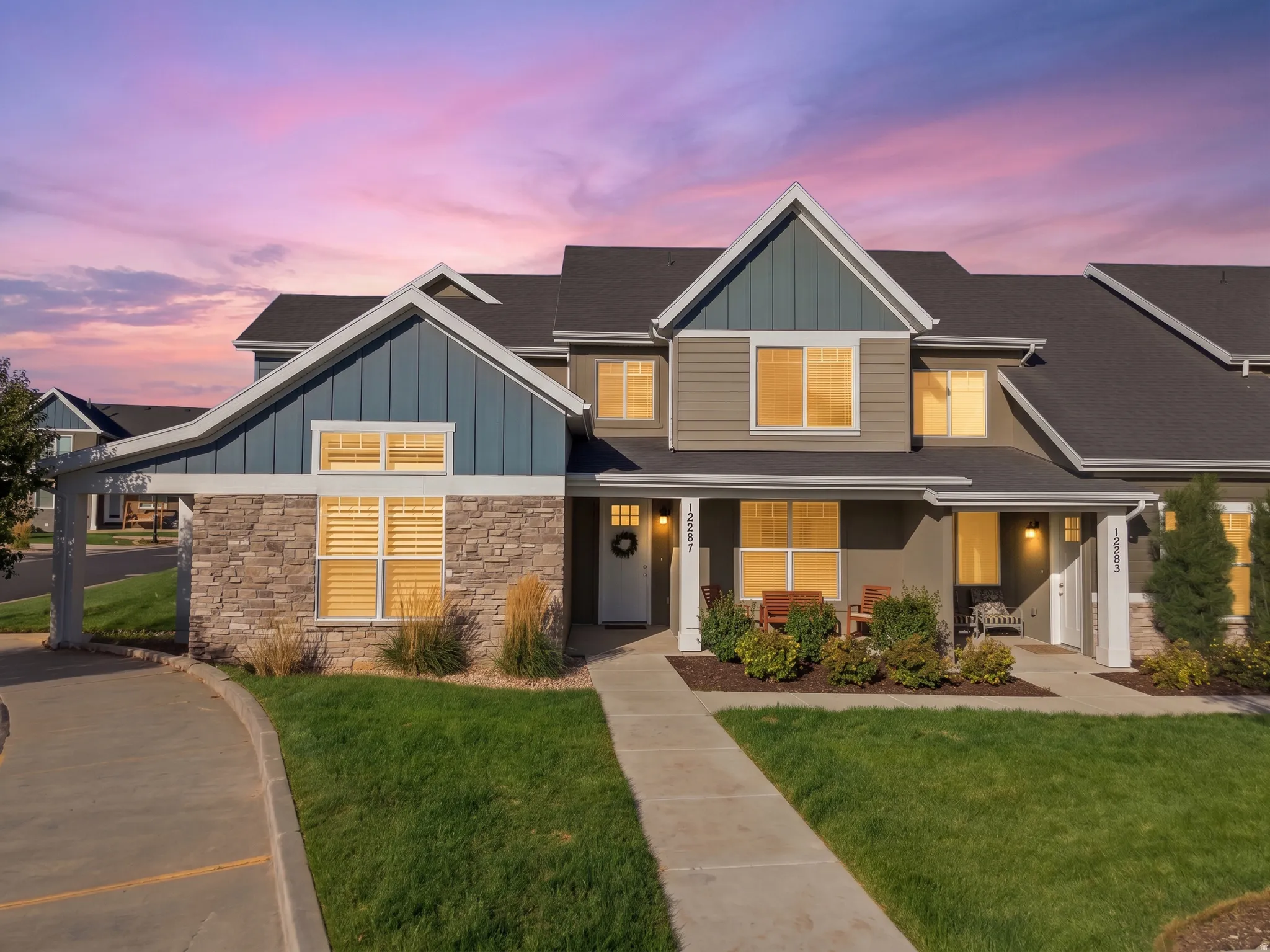 Contemporary exterior featuring stone accents, vertical siding, horizontal siding, and multiple gables