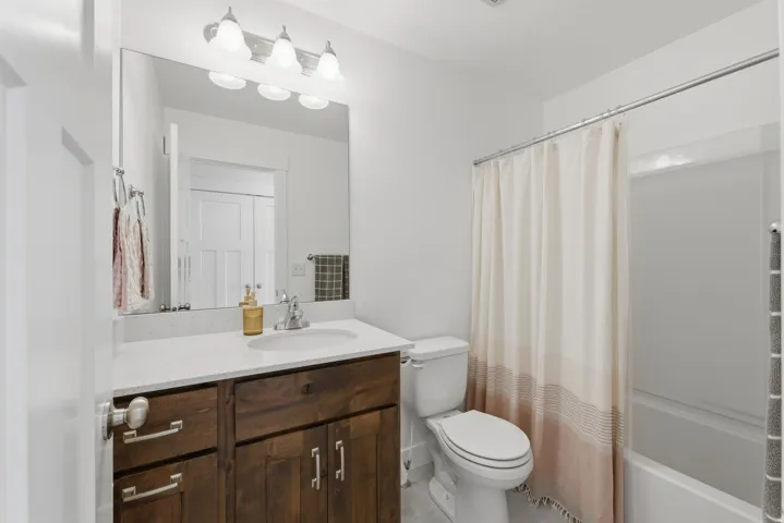 White shower-over-tub combination with a chrome shower rod