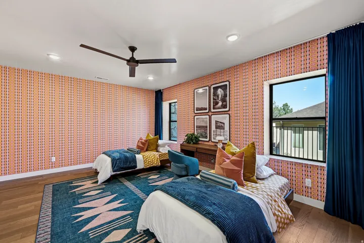Wood-finish flooring with recessed lighting, black ceiling fan, and two windows