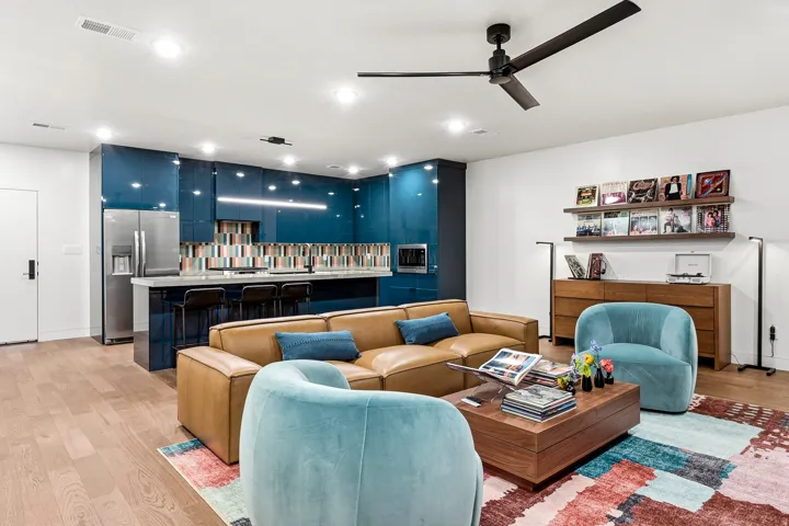 Open-concept living area featuring wood-finish flooring, recessed lighting, and a ceiling fan