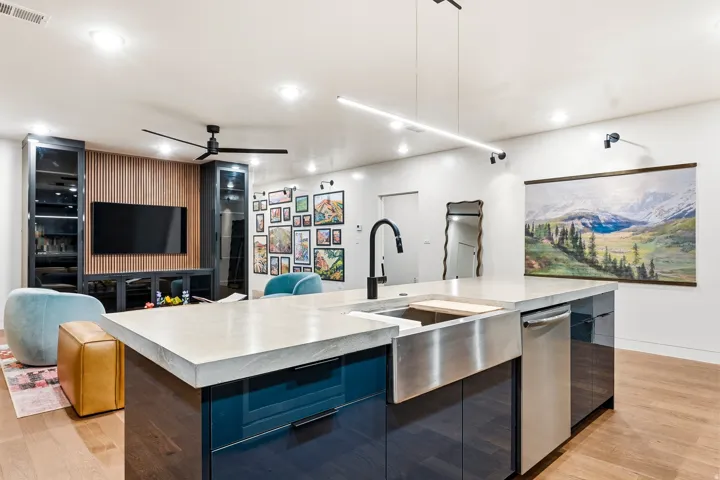 Spacious kitchen island with a farmhouse sink and stainless steel dishwasher