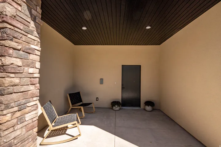 Textured stone column and stucco walls define this exterior space
