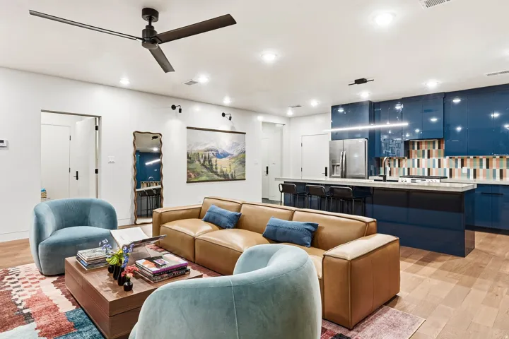 Open-concept living area with wood-finish flooring, a contemporary ceiling fan, and recessed lighting