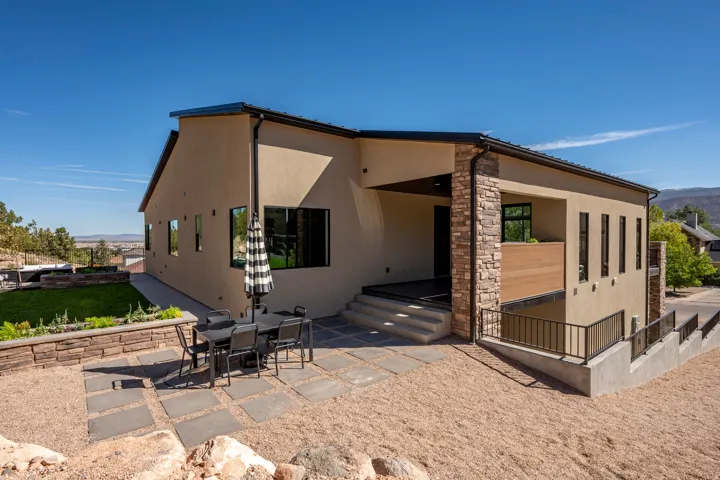Stucco exterior with stone accents, covered entry, and a multi-level design