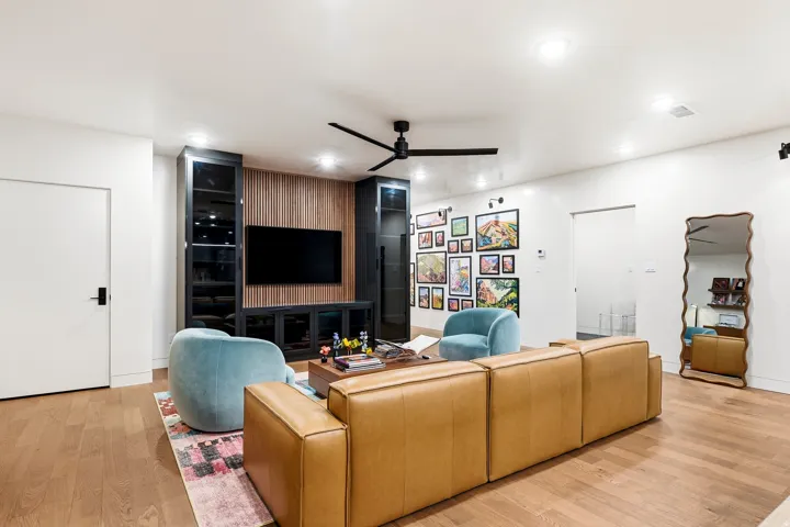 Hardwood flooring throughout, recessed lighting, and a contemporary ceiling fan