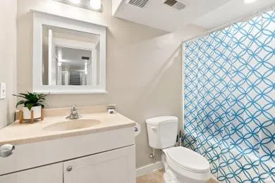 Vanity with an integrated sink, framed mirror, and chrome faucet