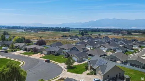 Residential development with varied architectural styles, mature landscaping, and mountain scenery