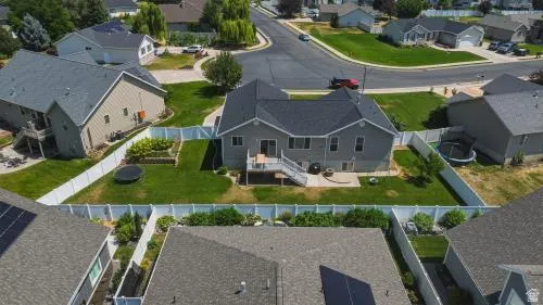 Two-story residence with a dark shingle roof and a lower-level walkout patio