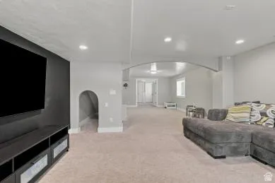 Spacious room with recessed lighting and neutral carpeting