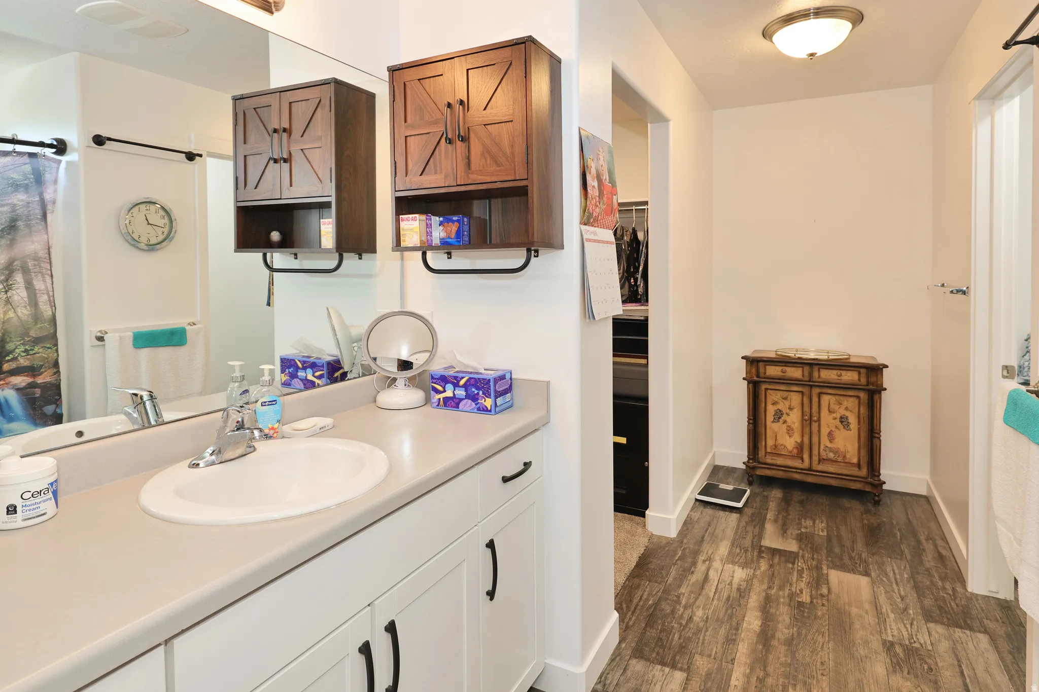 White vanity with an integrated sink, polished chrome faucet, and matte black hardware
