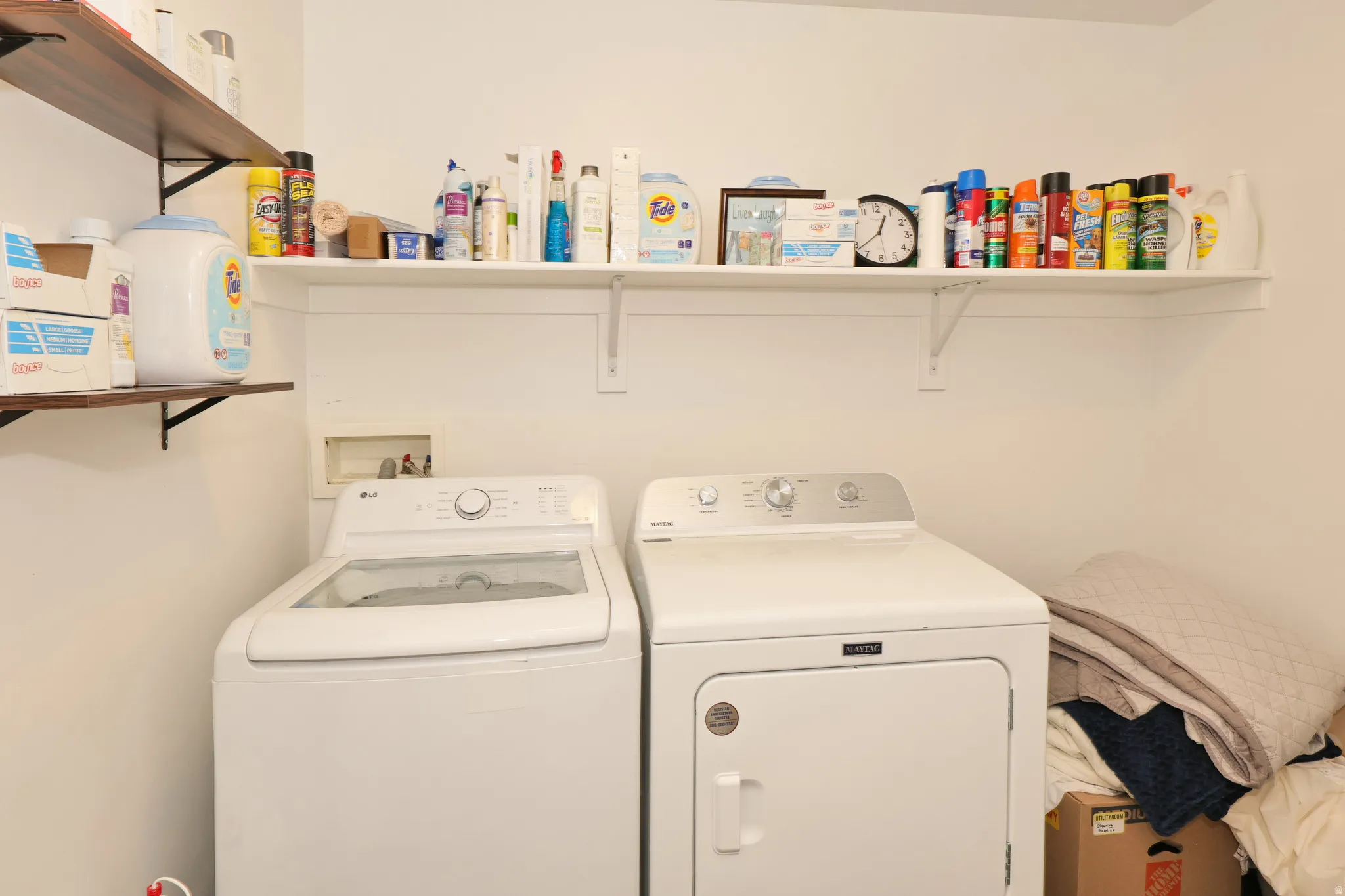 Laundry area with white walls and built-in shelving
