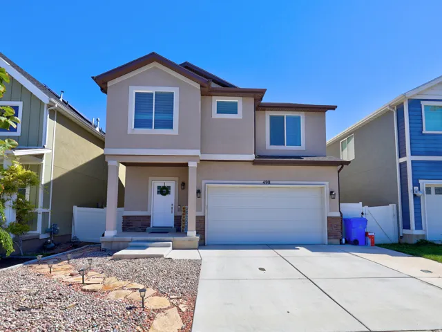 Two-story exterior with stucco siding and stone detailing
