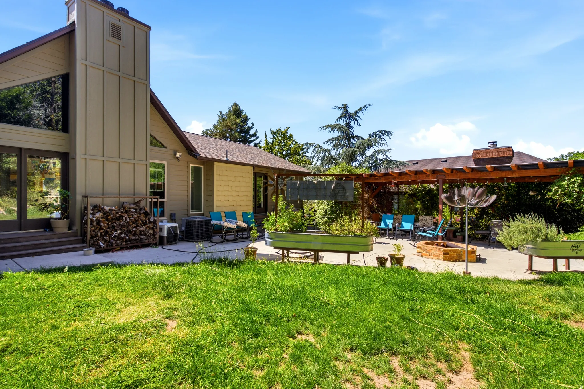 Expansive green lawn with a paver patio and a wood pergola