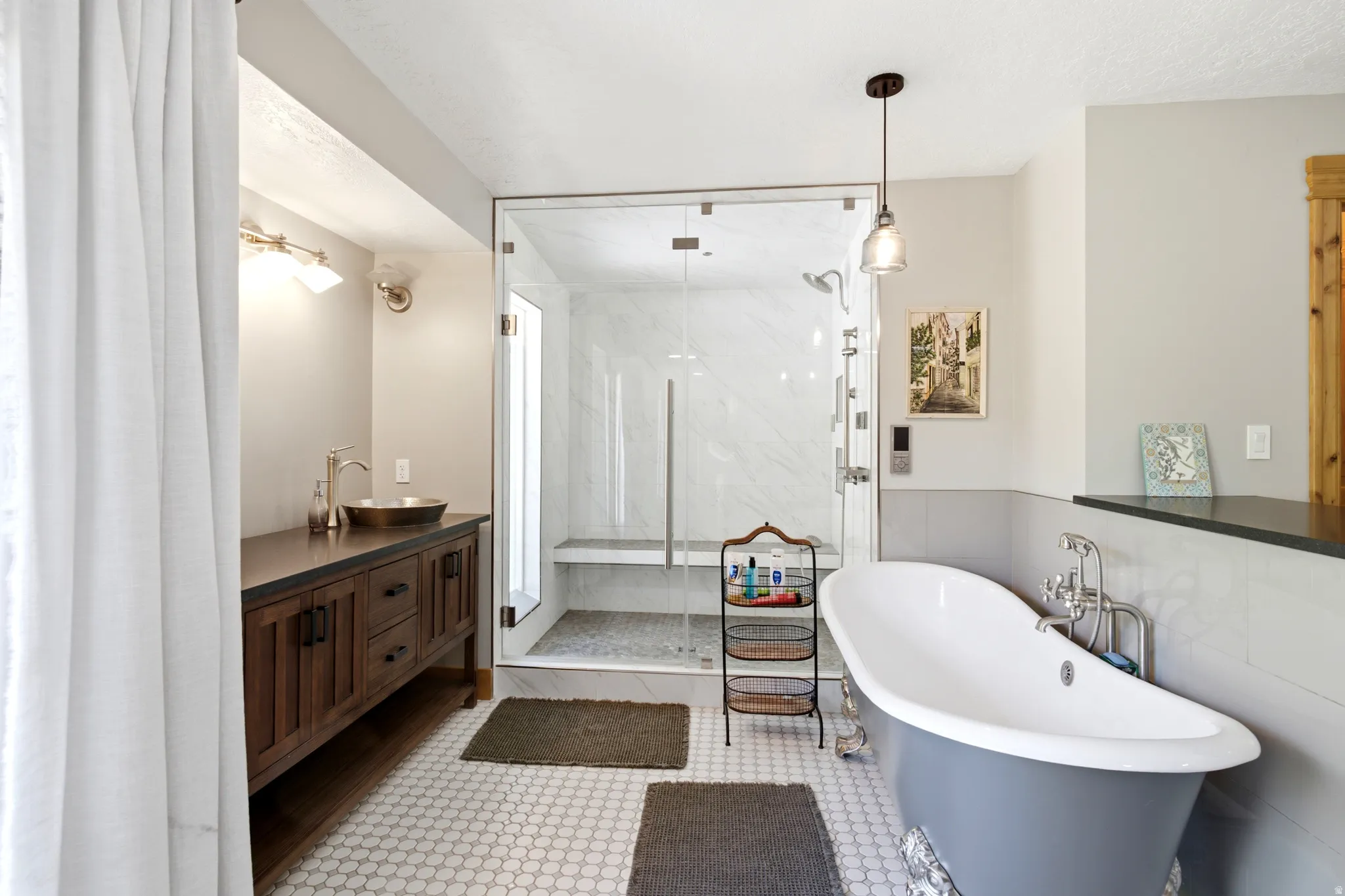 Walk-in shower with clear glass enclosure and integrated bench