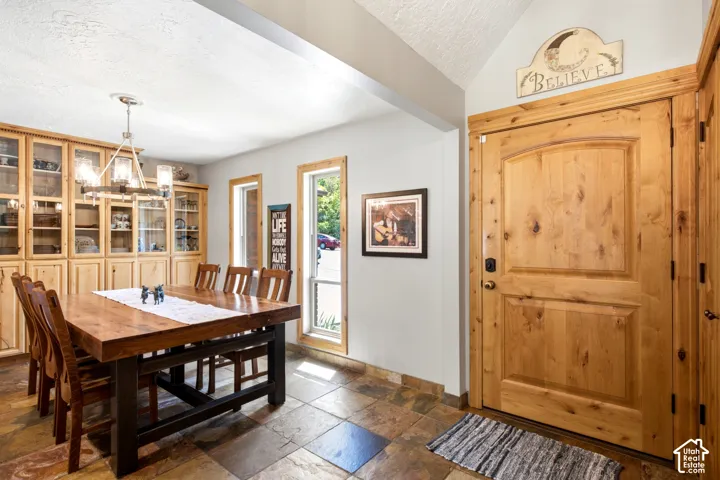 Built-in cabinetry with glass-front uppers, natural wood entry door, and multi-pane windows