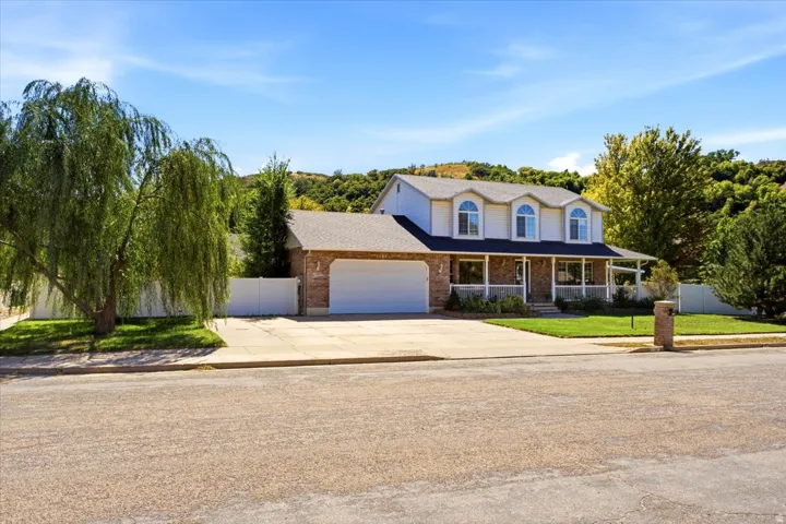 New roof (2021)! Ample parking includes RV pad plus extra-deep garage with insulated doors, & gas heater.