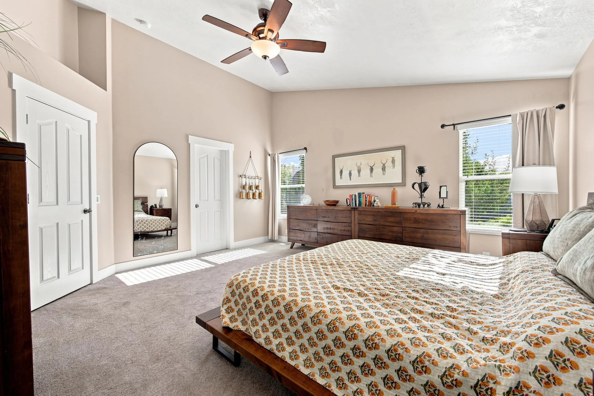 Recessed lighting, ceiling fan, vaulted ceiling, and multiple windows with blinds