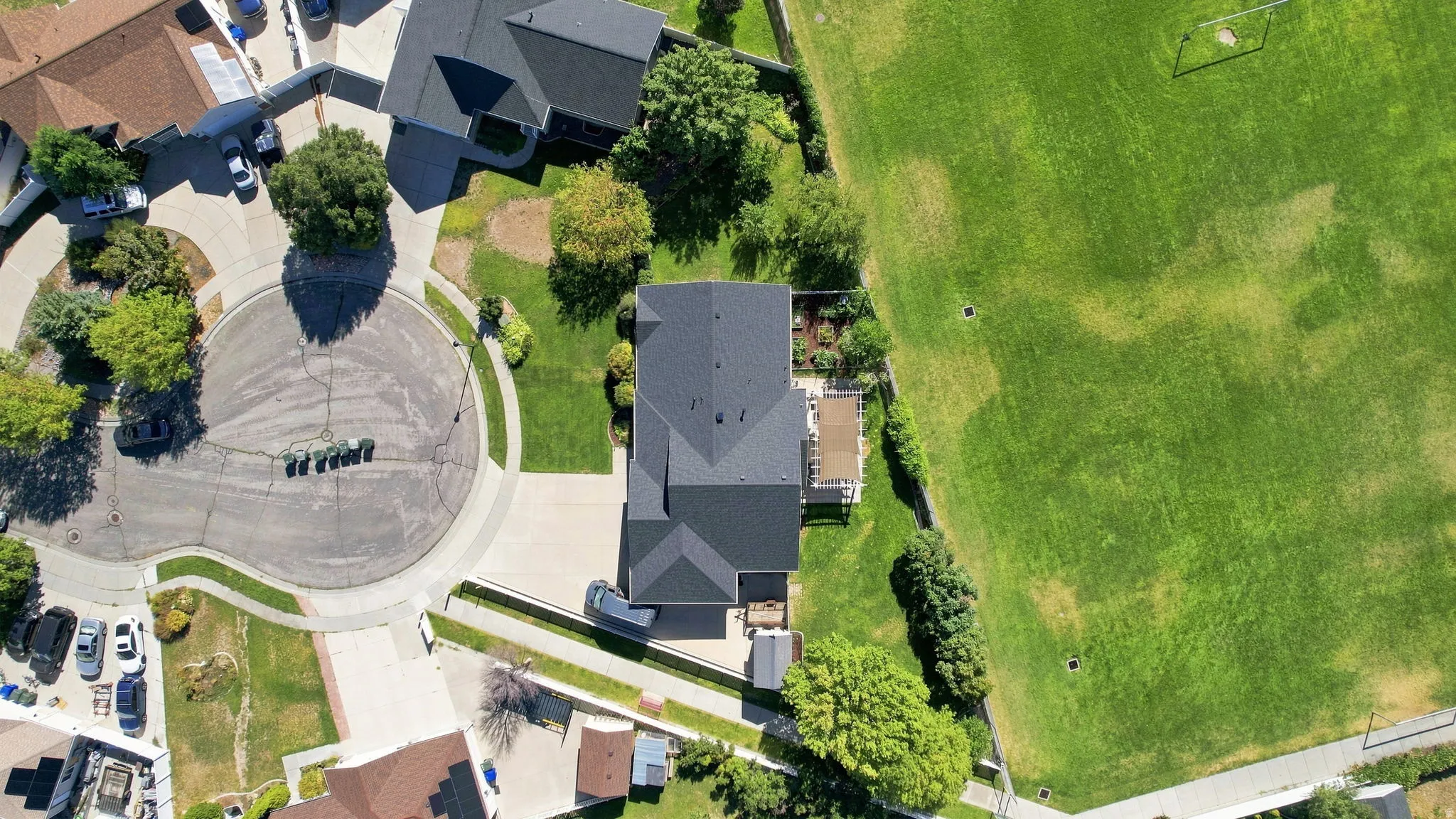 Property situated on a cul-de-sac street with a well-maintained lawn and a multi-level deck