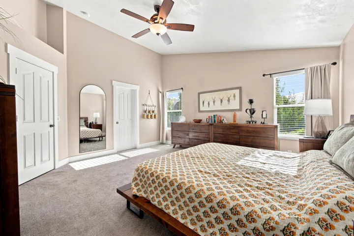 Recessed lighting, ceiling fan, vaulted ceiling, and multiple windows with blinds