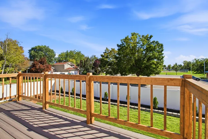 Composite deck flooring with a natural wood railing