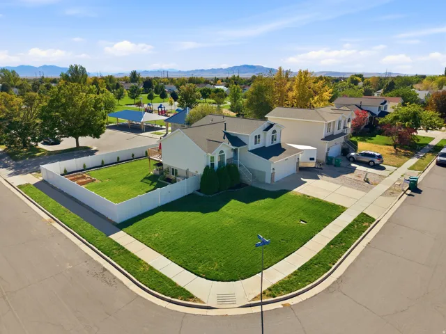 Two-story residence with a light-colored exterior and attached garage
