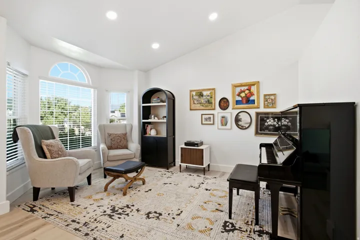 Vaulted ceilings, recessed lighting, and expansive windows with an arched transom