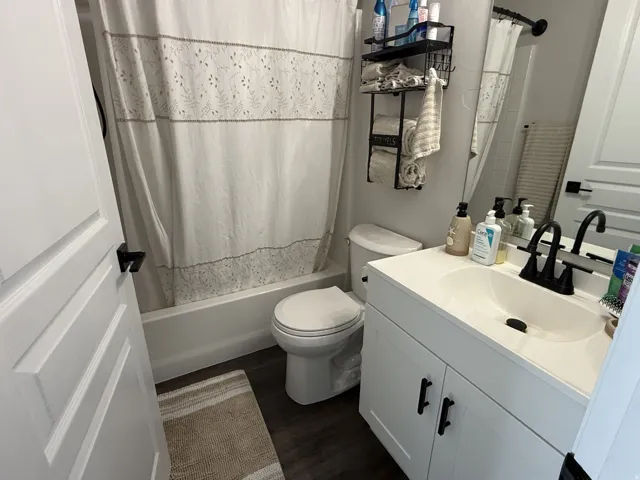 White vanity with an integrated sink and black faucet