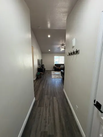 Wood-finish flooring throughout, vaulted ceilings, recessed lighting, and a ceiling fan
