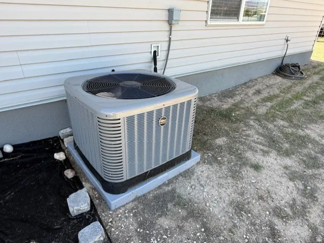 Exterior siding featuring an air conditioning unit on a concrete pad