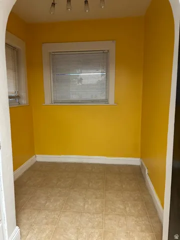Kitchen breakfast nook. two windows with blinds, recessed lighting, and bright yellow walls