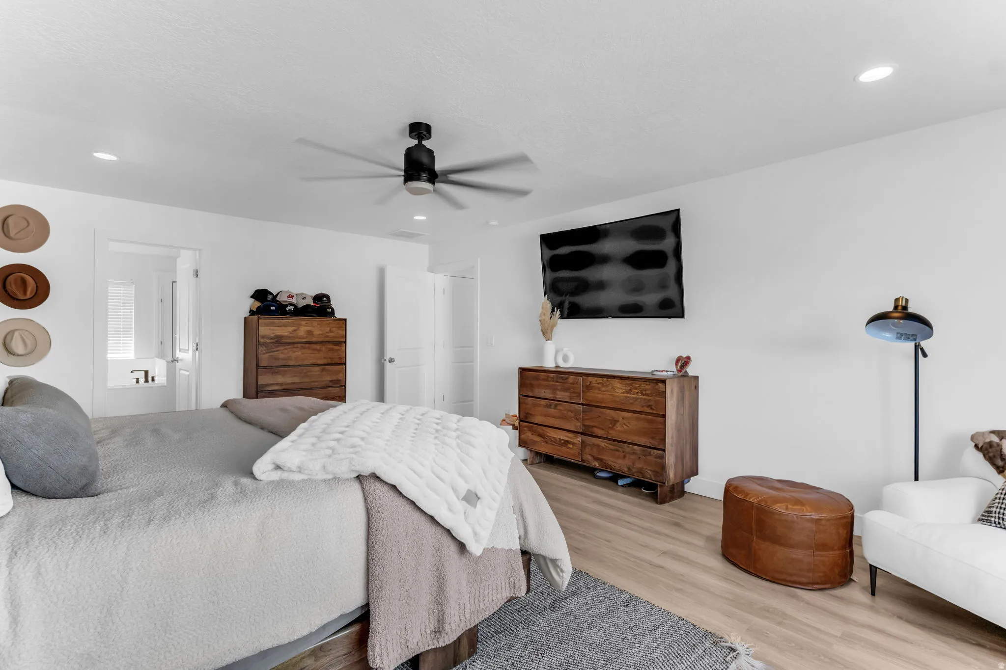 Recessed ceiling lighting, wood-finish flooring, and a ceiling fan