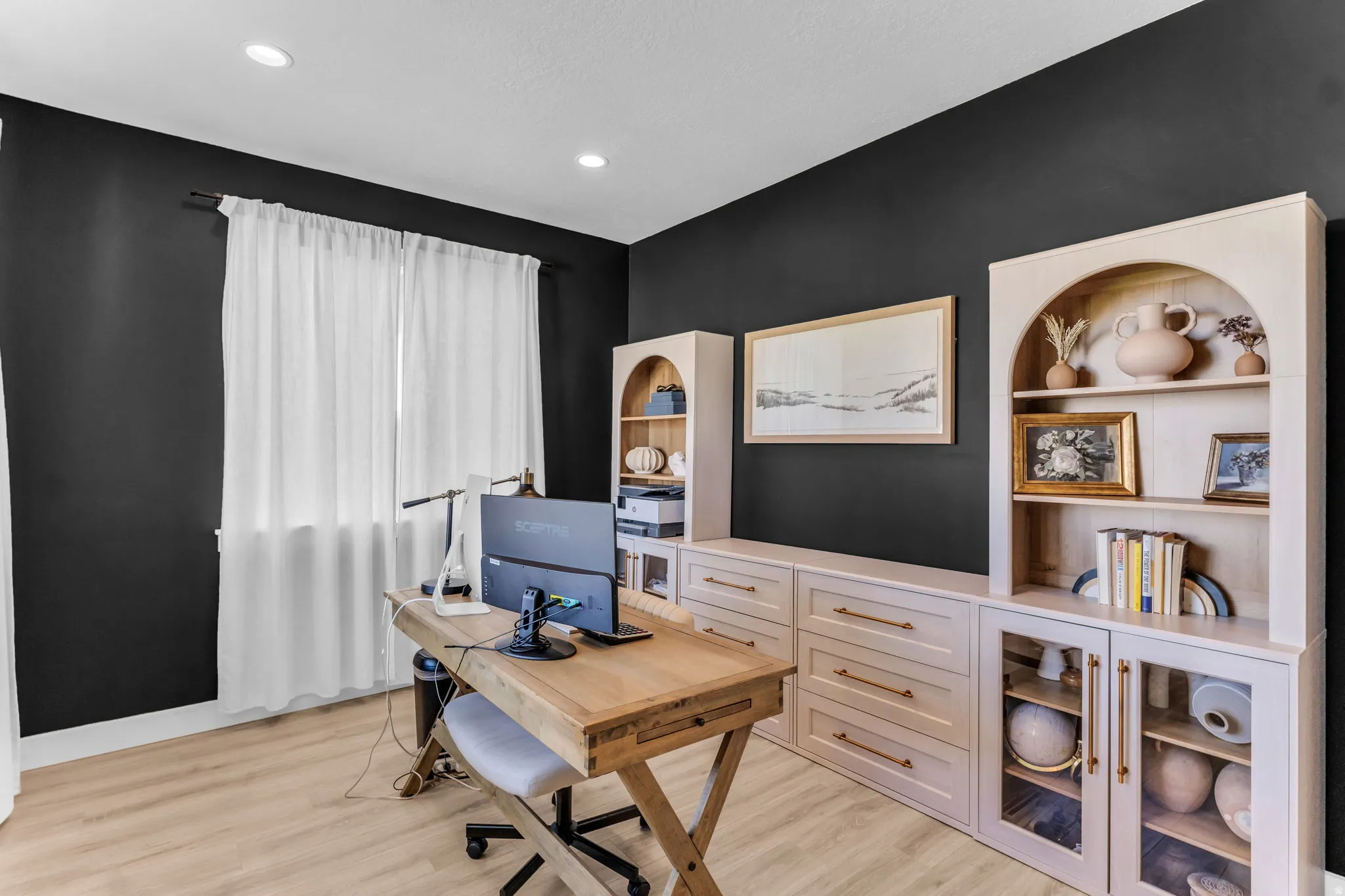 Recessed lighting, wood-finish flooring, custom built-in cabinetry, glass-front cabinets, and arch-top display shelving