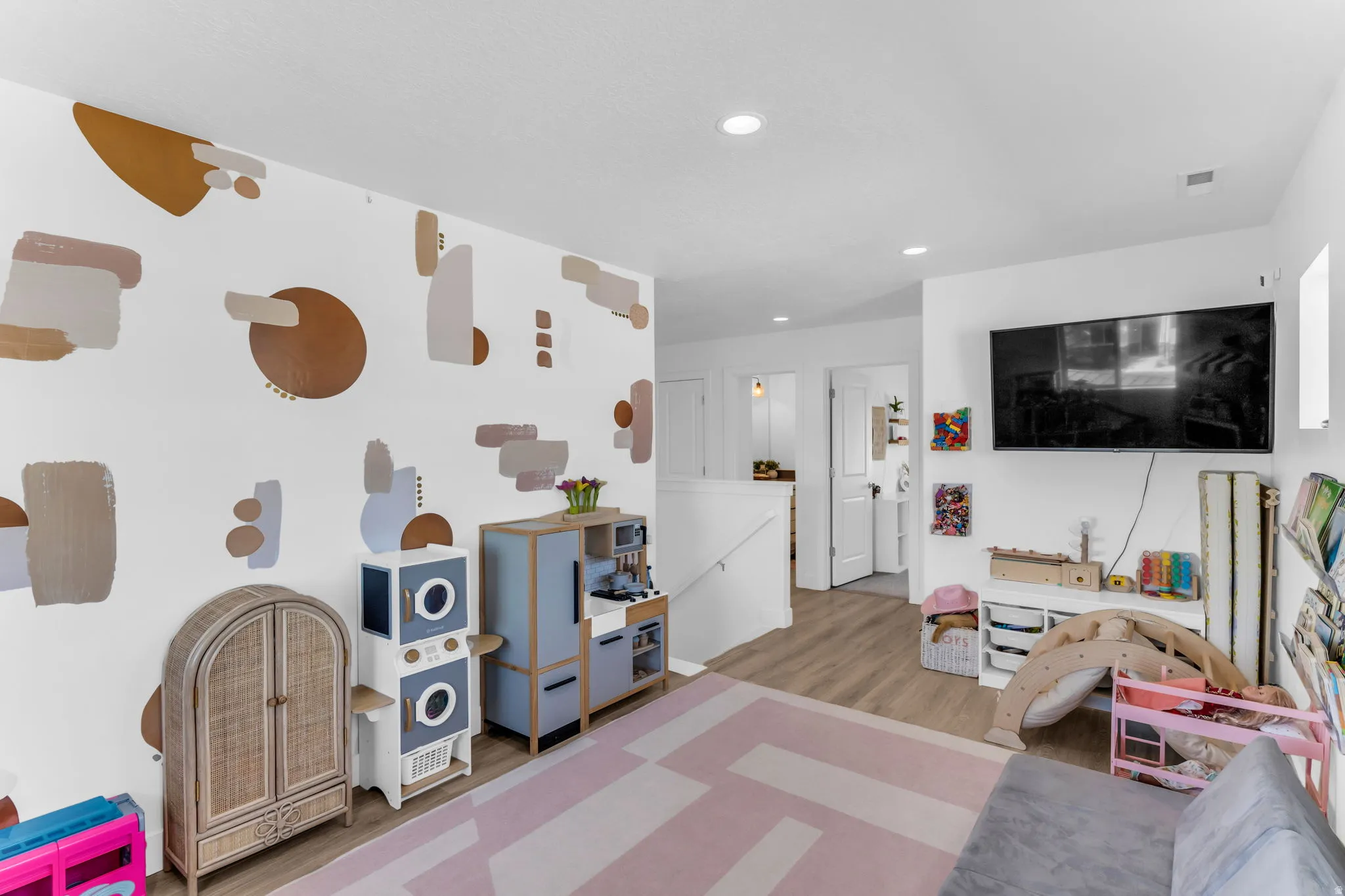 Recessed lighting illuminating wood-finish flooring
