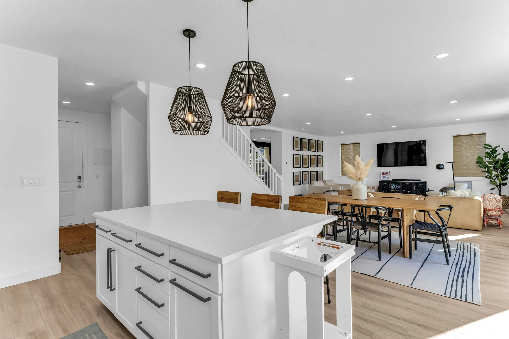 Spacious open-concept living area featuring light wood-finish flooring